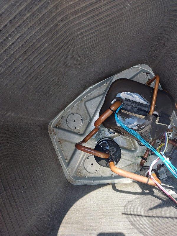 Responded to no cooling complaint on 3-year-old residential air conditioning system. Found outdoor unit fan motor operating but compressor not running. Removed top panel and inspected internal components. Diagnosed failed run capacitor preventing compressor from starting. Replaced defective dual run capacitor with proper rated replacement. Verified correct electrical connections, tested system operation, and confirmed compressor engaging properly with normal amp draw. System restored to full cooling capacity with proper airflow and temperature differential across coil.