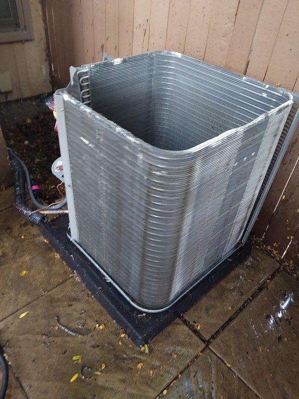Completed scheduled AC maintenance on residential heat pump system. Performed comprehensive inspection of outdoor condenser unit including cleaning of aluminum fin coils, verification of refrigerant line connections, and assessment of compressor operation. Unit found in good operating condition with proper installation on anti-vibration pad and secure electrical connections maintained.