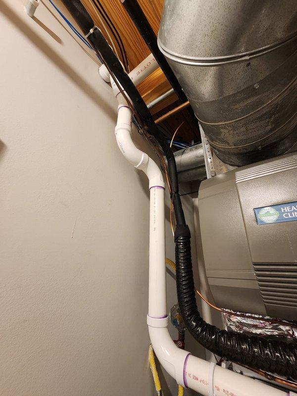 Completed warranty work replacing existing cellular core vent piping with solid core PVC piping on residential HVAC installation per manufacturer specifications. Verified all connections, proper venting configuration, and system operation. Documentation photos captured showing updated white PVC vent piping assembly, gas line connections, condensate components, and complete installation meeting code requirements.