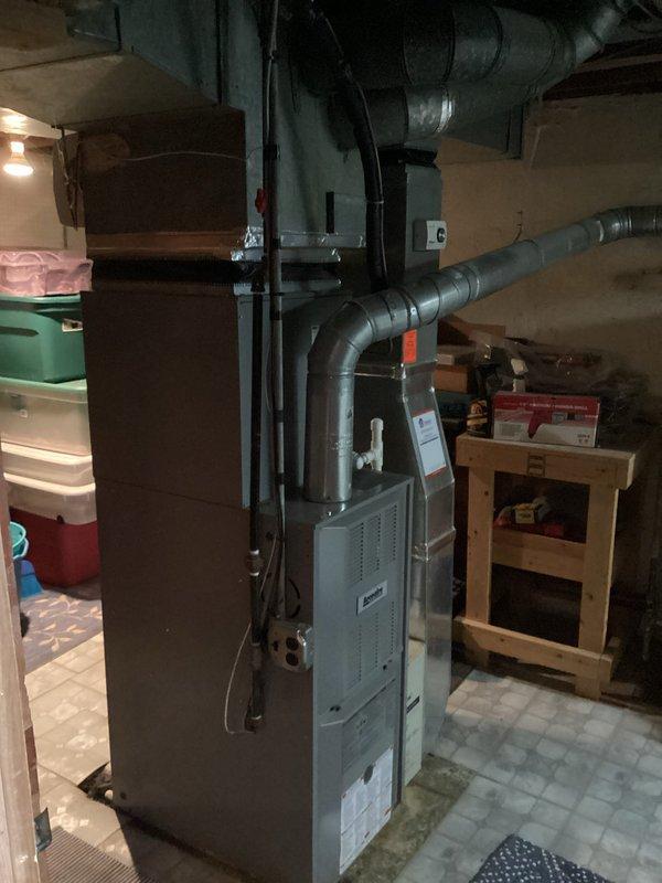 Conducted comprehensive assessment of existing residential HVAC system for replacement estimate purposes due to equipment age of 9-11 years. Evaluated furnace unit, ductwork configuration, and associated mechanical components in basement utility area. Documented current system specifications, installation layout, and accessibility factors through photographic records to provide accurate replacement pricing and equipment recommendations.
