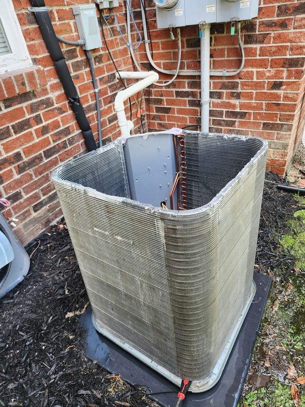 Completed scheduled preventative maintenance on residential air conditioning system. Performed comprehensive tune-up including inspection of outdoor condenser unit, verified proper operation of compressor and refrigerant lines, checked drain pan for proper drainage and condition, examined electrical connections and disconnect box, and inspected copper refrigerant tubing for leaks or damage. Cleaned condenser coils and exterior fins to remove dirt and debris accumulation. All components found operating within normal parameters with no issues identified. System ready for cooling season.
