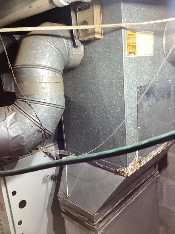 Conducted comprehensive HVAC system evaluation for non-operational furnace and hot water tank. Documented existing equipment conditions including attic-mounted air handler unit with flexible ductwork configuration and exterior electrical service connections, and provided replacement estimate with equipment options to restore heating and hot water functionality.