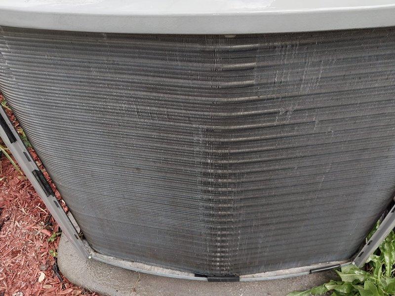 Completed routine AC maintenance on split system. Inspected indoor air handler evaporator coil and drain pan assembly, confirming proper drainage and insulation integrity on refrigerant lines. Examined outdoor condensing unit, noting exterior weathering and surface staining consistent with normal environmental exposure. All components operational with no immediate service needs identified.