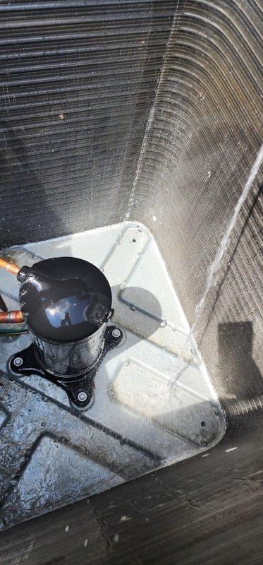 Completed comprehensive cooling system maintenance inspection on residential AC unit. Performed interior blower compartment assessment, documenting compressor condition and evaporator coil chamber configuration. Identified significant debris accumulation on outdoor condenser coil fins requiring attention to maintain optimal heat transfer efficiency and system performance.