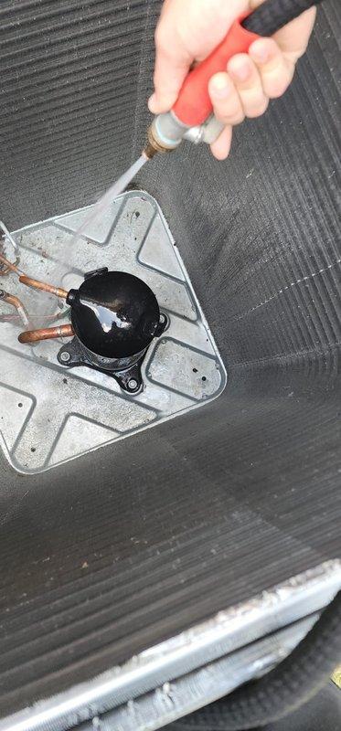 Completed scheduled AC maintenance on outdoor condensing unit. Inspected condenser coil which showed moderate dirt and debris accumulation between fins, cleaned compressor assembly and copper refrigerant lines, and applied appropriate maintenance treatment to compressor components to ensure optimal system performance and efficiency.