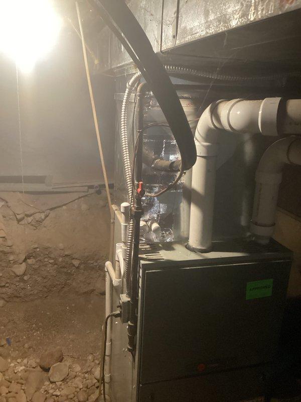 Completed comprehensive HVAC replacement estimate for residential air conditioning system. Documented existing furnace installation in basement utility area, including current configuration of PVC venting, flexible ductwork connections, and equipment placement alongside water heater. Assessed crawl space installation conditions, structural considerations, and existing infrastructure to provide accurate replacement recommendations for new AC system integration with current heating equipment.