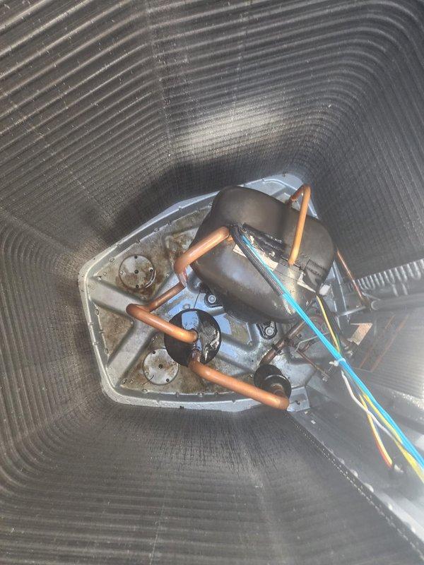 Completed comprehensive cooling season maintenance on residential air conditioning system under prepaid maintenance plan. Performed standard tune-up procedures including inspection of outdoor condenser unit, compressor assembly, refrigerant lines, and electrical connections. Verified proper operation of condenser fan motor and checked all copper refrigerant line connections for integrity. System found operating within normal parameters with no deficiencies noted. Unit serviced in outdoor location adjacent to building structure with adequate clearance maintained around condenser for proper airflow. All components inspected and confirmed in good working condition with no repairs required at this time.