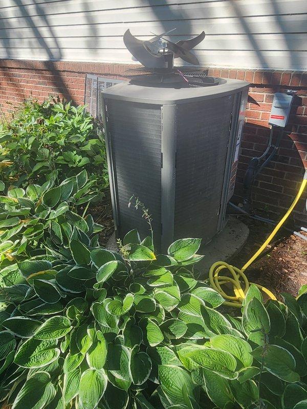 Completed comprehensive cooling season maintenance on residential air conditioning system under prepaid maintenance plan. Performed standard tune-up procedures including inspection of outdoor condenser unit, compressor assembly, refrigerant lines, and electrical connections. Verified proper operation of condenser fan motor and checked all copper refrigerant line connections for integrity. System found operating within normal parameters with no deficiencies noted. Unit serviced in outdoor location adjacent to building structure with adequate clearance maintained around condenser for proper airflow. All components inspected and confirmed in good working condition with no repairs required at this time.