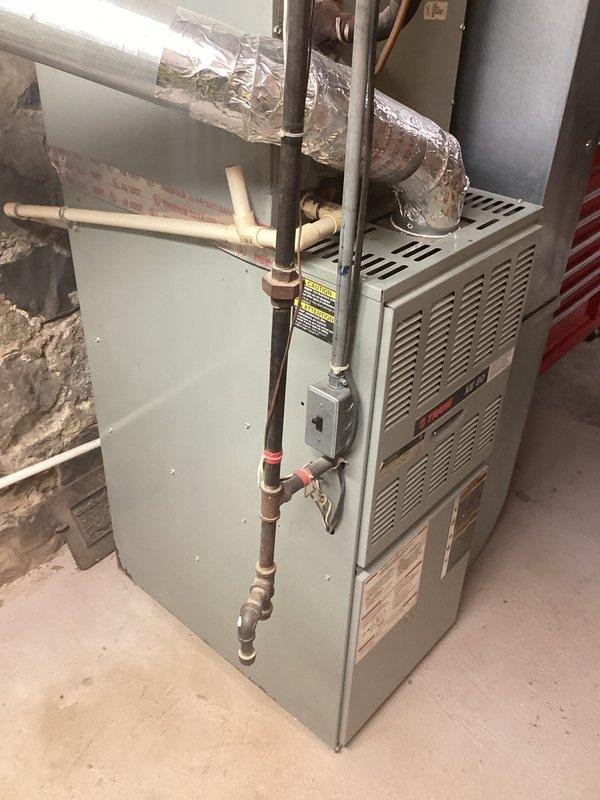 Conducted estimate for replacement of 10-year-old natural gas furnace system currently located in basement utility room. Existing equipment remains operational but customer seeking replacement options. Documented current installation including furnace unit, air handler, gas line connections with shut-off valve, PVC condensate drainage, and flexible ductwork to provide accurate replacement specifications and equipment recommendations.