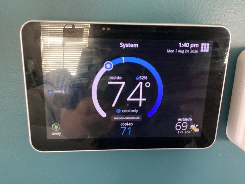 Successfully completed installation of Lennox air conditioning system including outdoor condensing unit mounted on concrete pad with proper gravel drainage bed, refrigerant line set with insulated suction line and liquid line connected via brass service valves, and digital smart thermostat programmed and operational in cooling mode.