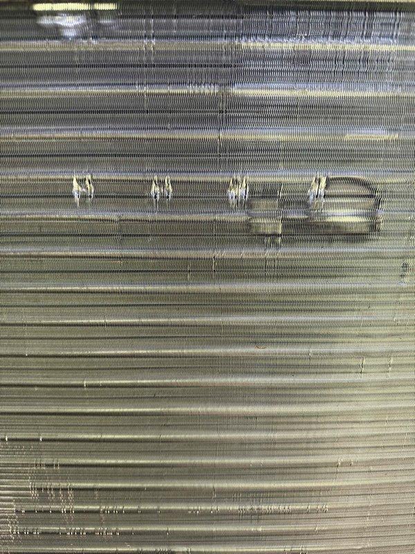 Completed installation of Lennox air conditioning system and performed callback service to straighten damaged evaporator coil fins. Inspection revealed bent and compressed fins with dirt accumulation and oxidation on the heat exchanger surfaces, which were carefully straightened using fin comb tools to restore proper airflow and heat transfer efficiency.