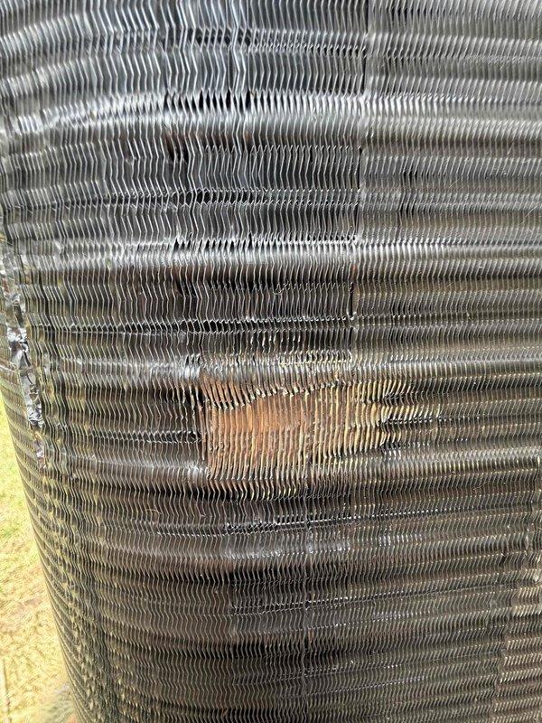 Completed installation of Lennox air conditioning system and performed callback service to straighten damaged evaporator coil fins. Inspection revealed bent and compressed fins with dirt accumulation and oxidation on the heat exchanger surfaces, which were carefully straightened using fin comb tools to restore proper airflow and heat transfer efficiency.