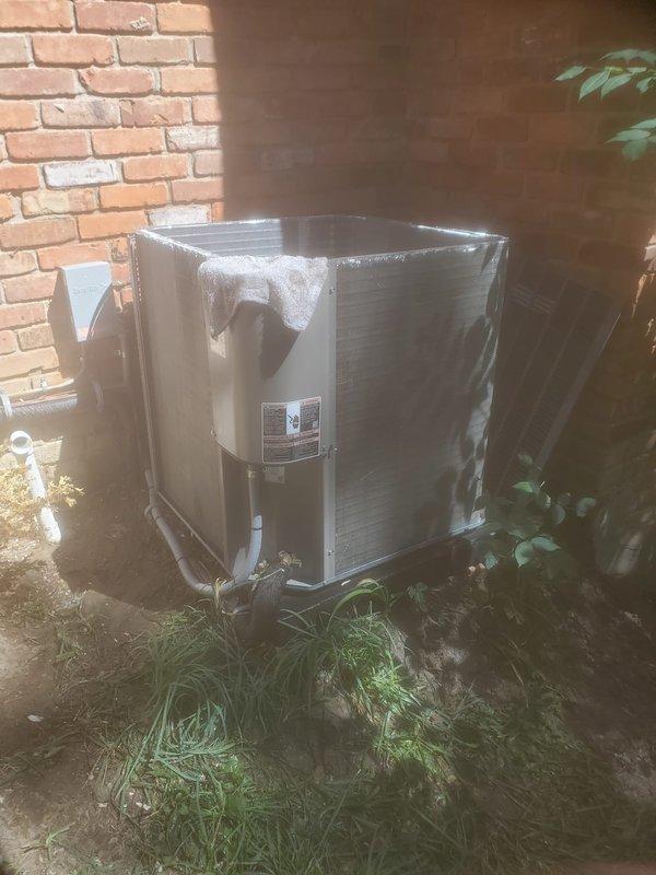 Completed comprehensive cooling system maintenance inspection on residential air conditioning system. Documented outdoor condensing unit with protective wrapping still in place and inspected ceiling-mounted indoor components including thermostat wiring connections. All equipment photographed for service records and system verified operational per Worry Free Service Agreement standards.