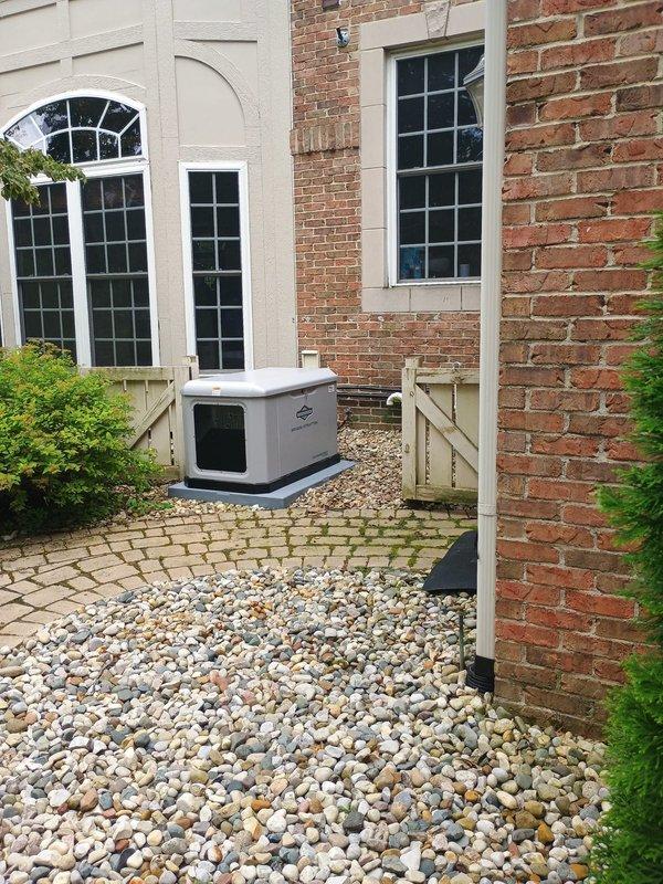 Completed replacement installation of Briggs & Stratton 26kW standby generator unit at residential property. Removed existing generator system and installed new unit on concrete pad against brick exterior wall, establishing all necessary electrical connections, gas line hookups, and exhaust routing per manufacturer specifications and local code requirements.
