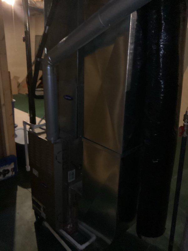 Completed comprehensive replacement estimate for 22-year-old original HVAC system in residential basement mechanical room. System remains operational but has reached end of expected service life. Documented existing furnace/air handler configuration, ductwork layout, and clearances. Photographed current equipment specifications, venting arrangement, and surrounding mechanical infrastructure including water heater proximity and available workspace for replacement installation.