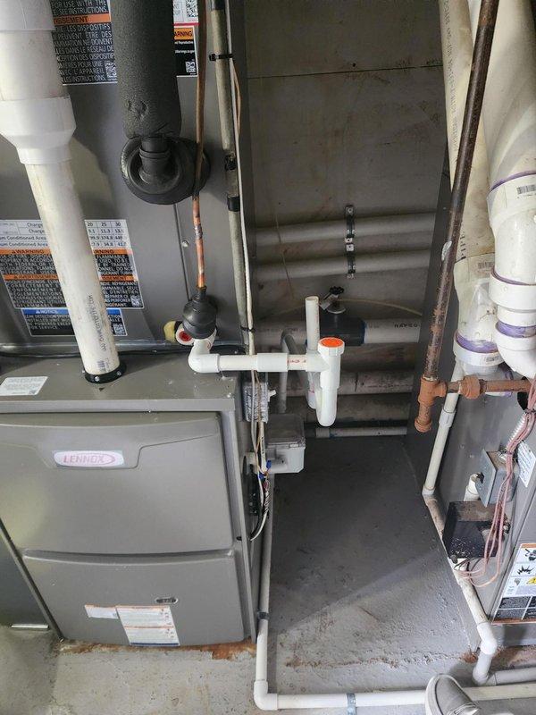 Responded to callback for HVAC installation to address drainage concerns. Repositioned and secured PVC condensate drain line to ensure proper fit against Lennox furnace unit, eliminating gaps and potential leak points. Applied mortar sealant around exterior PVC penetration through brick wall to weatherproof the installation and prevent moisture intrusion, completing the corrective work per original installation specifications.