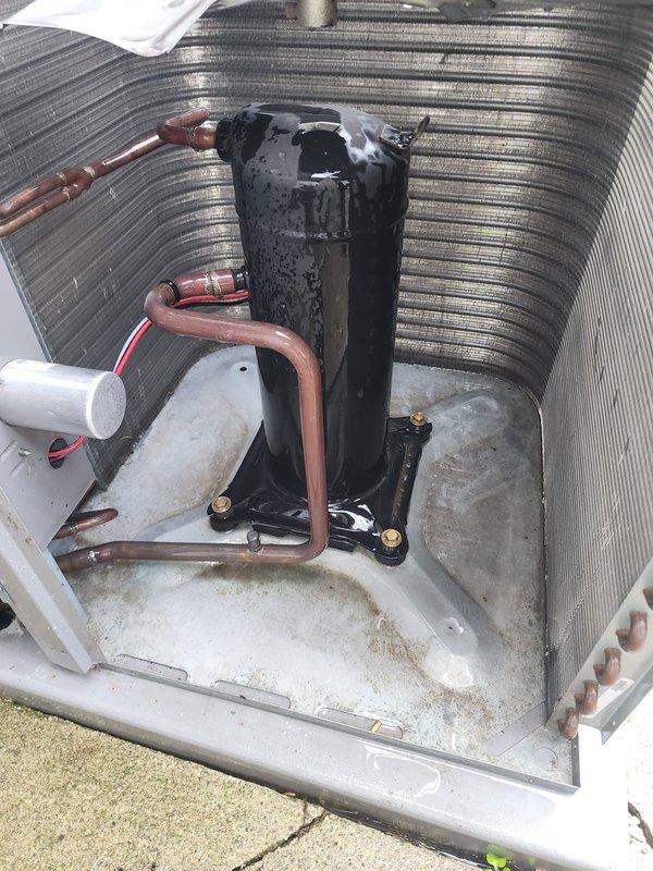 # AC Maintenance Service Completed

Performed comprehensive preventive maintenance on residential outdoor condensing unit. Conducted visual inspection of compressor assembly, refrigerant lines, and electrical connections. Compressor showed normal condensation indicating recent operation in humid conditions. Copper refrigerant lines verified intact with proper routing and no visible damage. Base pan exhibited typical outdoor weathering with minor surface oxidation and dirt accumulation, cleaned as needed. Verified condensate drain line clear and functioning properly. Inspected condenser coil fins for debris and airflow restrictions. Fan motor and grille assembly checked for proper operation, noted age-related surface rust on motor hub consistent with outdoor exposure. All electrical connections secure. Unit operating within normal parameters. Recommended continued annual maintenance to ensure optimal system performance and longevity.