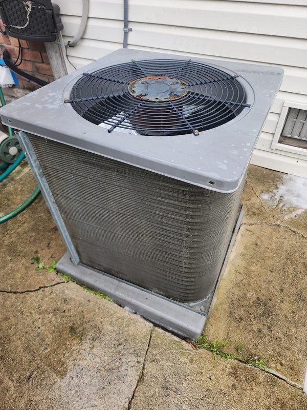 # AC Maintenance Service Completed

Performed comprehensive preventive maintenance on residential outdoor condensing unit. Conducted visual inspection of compressor assembly, refrigerant lines, and electrical connections. Compressor showed normal condensation indicating recent operation in humid conditions. Copper refrigerant lines verified intact with proper routing and no visible damage. Base pan exhibited typical outdoor weathering with minor surface oxidation and dirt accumulation, cleaned as needed. Verified condensate drain line clear and functioning properly. Inspected condenser coil fins for debris and airflow restrictions. Fan motor and grille assembly checked for proper operation, noted age-related surface rust on motor hub consistent with outdoor exposure. All electrical connections secure. Unit operating within normal parameters. Recommended continued annual maintenance to ensure optimal system performance and longevity.