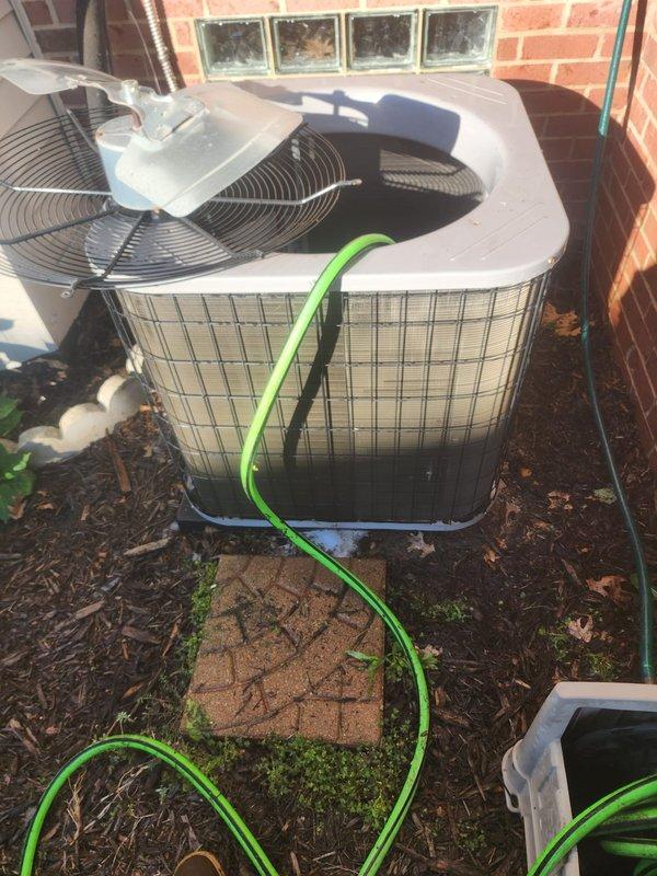 Performed comprehensive AC tune-up on outdoor condensing unit located on exterior concrete pad. Inspected condenser fan motor assembly, verified electrical connections, and checked fan blade operation. Cleaned condenser coils and exterior surfaces, removed accumulated debris from unit housing and surrounding area. Verified proper airflow through protective grilles and confirmed system operational status. Unit showed normal wear patterns consistent with regular outdoor exposure; all components functioning within manufacturer specifications at time of inspection.