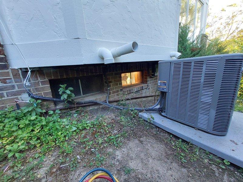 Responded to no cooling complaint for second opinion evaluation on residential HVAC system over 10 years old. Previous contractor had diagnosed refrigerant leak. Performed comprehensive system inspection of outdoor condensing unit and refrigerant line routing along building foundation. Assessed unit condition, refrigerant line integrity, and electrical connections. Documented equipment installation and surrounding area conditions for diagnostic purposes.