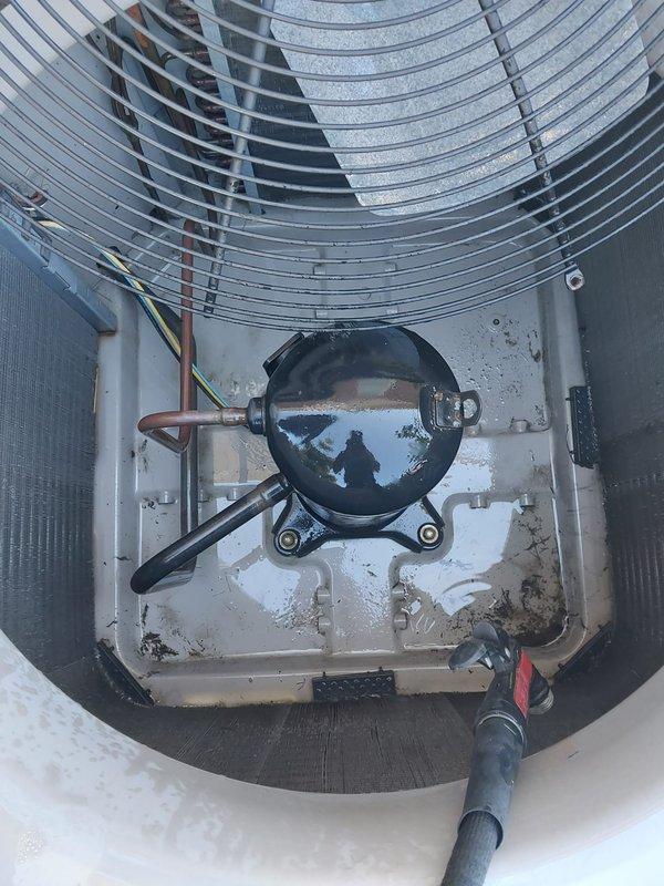 Completed comprehensive maintenance service on residential outdoor condensing unit. Performed standard 10-12 point inspection including visual examination of compressor assembly, refrigerant line connections, electrical wiring, fan motor operation, and condenser coil condition. Verified proper mounting and hardware security, confirmed unit operational status, and documented equipment condition with exterior and interior component photography. All components found in satisfactory working order with normal wear patterns consistent with outdoor installation.