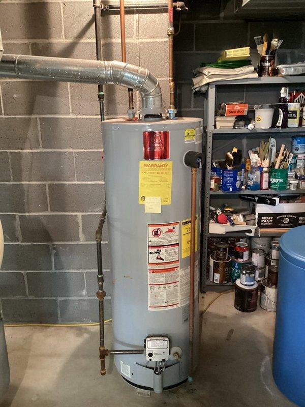 Conducted comprehensive on-site assessment of existing residential water heater installation in basement utility area. Evaluated current unit condition, venting configuration with galvanized metal ductwork, copper supply line connections, and overall system layout. Documented equipment specifications, clearance requirements, and existing plumbing connections to prepare detailed replacement estimate for homeowner consideration.