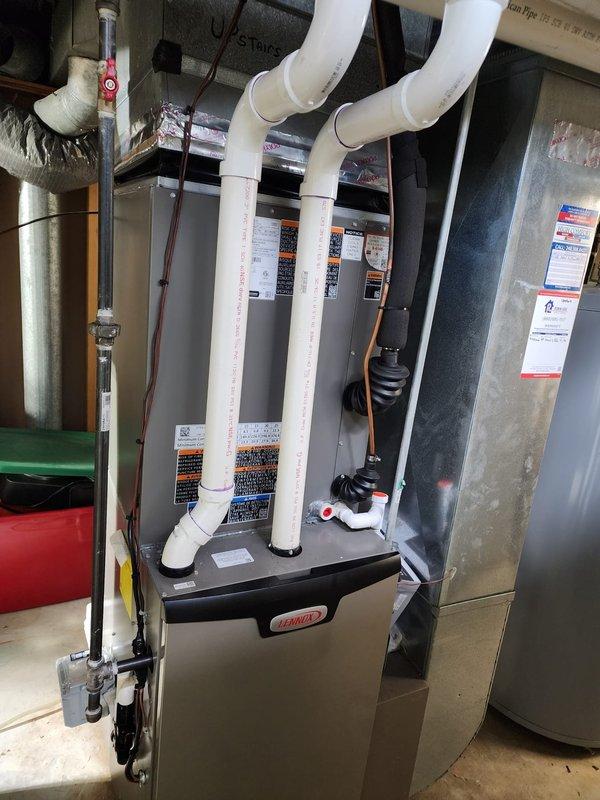 Completed installation of new Lennox air conditioning system with S40 smart thermostat. Installed outdoor condensing unit on exterior pad with proper refrigerant line connections, electrical disconnect box, and PVC condensate drain line routed to grade. Connected system to existing Lennox furnace in basement mechanical room, verified all refrigerant lines properly insulated, and programmed S40 thermostat for optimal performance.