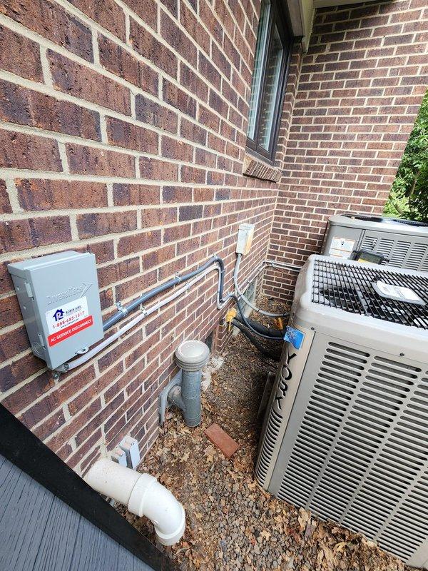 Completed installation of new Lennox air conditioning system with S40 smart thermostat. Installed outdoor condensing unit on exterior pad with proper refrigerant line connections, electrical disconnect box, and PVC condensate drain line routed to grade. Connected system to existing Lennox furnace in basement mechanical room, verified all refrigerant lines properly insulated, and programmed S40 thermostat for optimal performance.