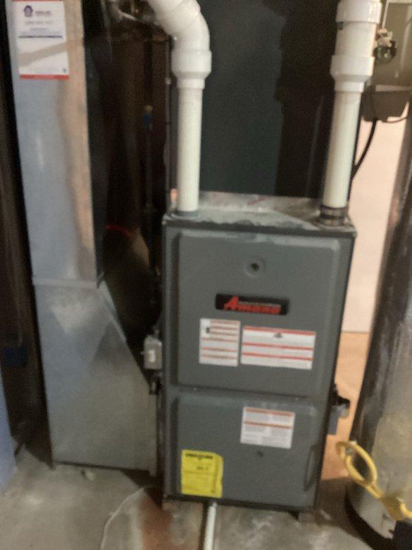 Completed comprehensive replacement estimate for residential HVAC system including existing Amana furnace unit located in basement utility area and associated ductwork components in attic mechanical space. Documented current equipment conditions, photographed existing installations including furnace with PVC venting system and attic-mounted air handler with flexible duct connections, and assessed replacement requirements for complete system upgrade.