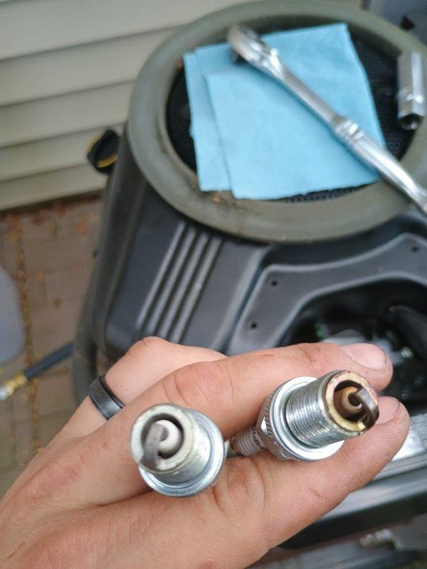 Performed scheduled maintenance on residential Vanguard 627cc standby generator unit. Inspected and replaced worn spark plugs showing carbon deposits and electrode wear. Verified all electrical connections, control box wiring, and mounting hardware for proper operation and security.
