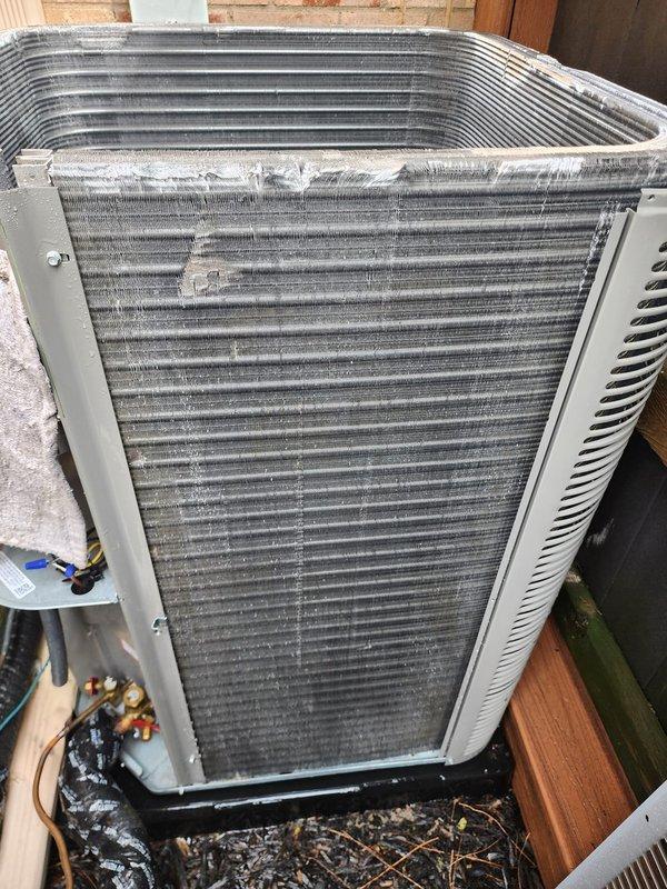 Completed routine maintenance on residential air conditioning system as part of prepaid service plan. Inspected outdoor condenser unit, noting accumulated debris around base and dust buildup on aluminum cooling fins. Examined compressor assembly and refrigerant lines with service ports intact. All major components operational with no immediate issues identified during inspection.