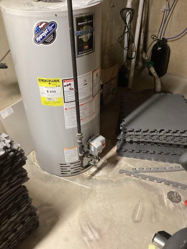 Completed estimate for hot water heater replacement in basement utility area. Assessed existing InfinitePac water heater installation, documented current equipment specifications including Energy Guide ratings, and photographed existing plumbing connections including copper supply lines, PVC venting, gas valve assembly, and shut-off valves. Provided replacement options and pricing for new water heater installation.