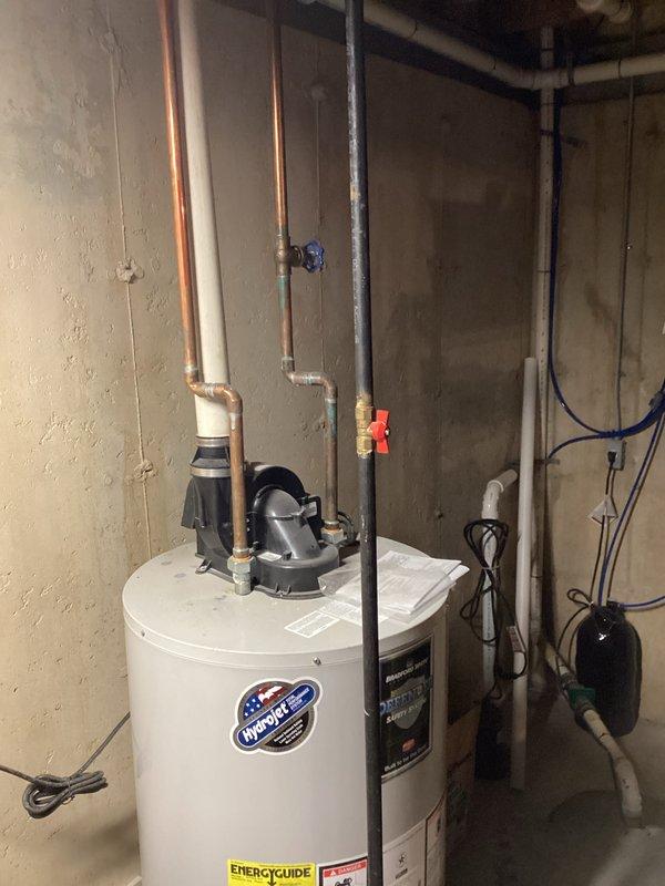 Completed estimate for hot water heater replacement in basement utility area. Assessed existing InfinitePac water heater installation, documented current equipment specifications including Energy Guide ratings, and photographed existing plumbing connections including copper supply lines, PVC venting, gas valve assembly, and shut-off valves. Provided replacement options and pricing for new water heater installation.