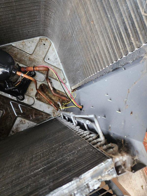 Completed scheduled AC maintenance on residential split system. Performed comprehensive inspection of indoor evaporator coil unit and outdoor condensing unit, including examination of refrigerant lines, electrical connections, and heat exchanger components. All coils, copper line sets, wiring connections, and mechanical components found to be intact and operational with normal wear patterns for system age.
