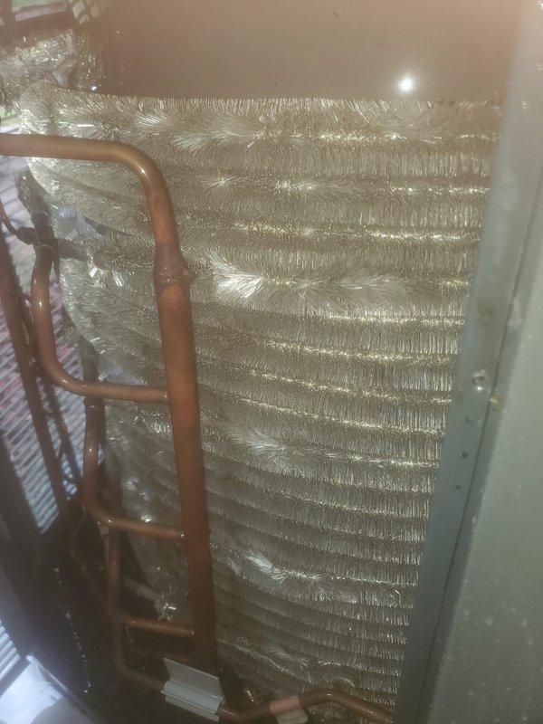 Completed preventive maintenance inspection on residential air conditioning system per Worry Free Service Agreement protocol. Upon inspection, discovered significant frost and ice accumulation on evaporator coil, indicating potential airflow restriction or refrigerant charge issue. Documented compressor assembly condition and refrigerant line configuration with photographic evidence. System requires follow-up evaluation to address frost buildup and ensure proper cooling operation.