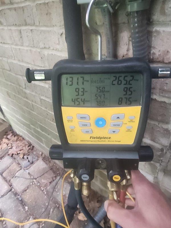 Completed preventative maintenance on residential air conditioning system under Worry Free Service Agreement. Performed system diagnostics using digital manifold gauges to verify refrigerant pressures and temperatures, confirming proper operating parameters. Inspected outdoor condenser unit, verified clean coil fins, checked electrical connections and conduit routing, and confirmed unit is properly mounted on concrete pad with adequate clearance beneath deck structure.