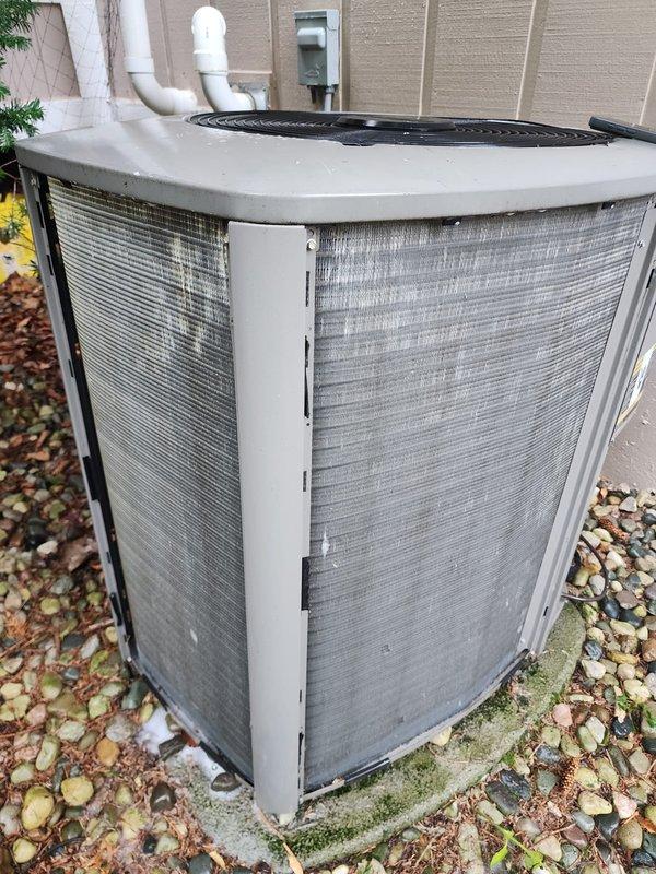 Completed scheduled AC tune-up maintenance on residential air conditioning system. Performed comprehensive inspection of outdoor condenser unit, verified proper operation of compressor and refrigerant lines, and documented system condition through photography. Noted visible staining and moisture accumulation in drain pan, though unit is operating within normal parameters at this time.