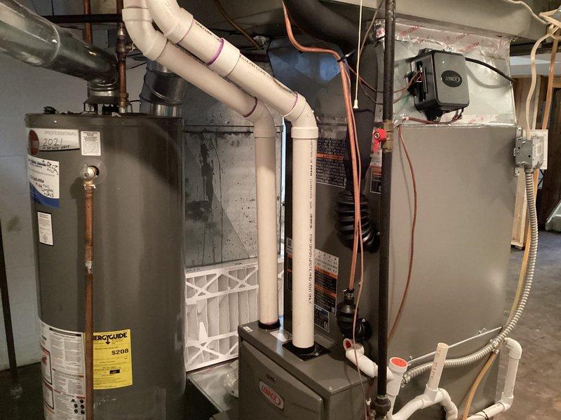 Completed installation of new Lennox air conditioning system in residential basement mechanical room, utilizing existing electrical infrastructure from previously removed unit. Successfully connected refrigerant lines to indoor air handler, integrated condensate drainage with existing PVC system, and verified all mechanical and electrical connections for proper operation.