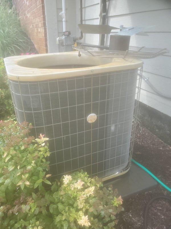 Completed routine preventative maintenance on residential air conditioning system as part of cooling season service agreement. Performed standard inspection of outdoor condenser unit and indoor evaporator components, documenting equipment condition through photographic records. Observed condensate drain pan showing mineral deposits and biological growth accumulation, indicating normal system operation with adequate drainage function. Exterior condenser unit found in satisfactory operating condition with proper clearances maintained from landscaping and building structure.