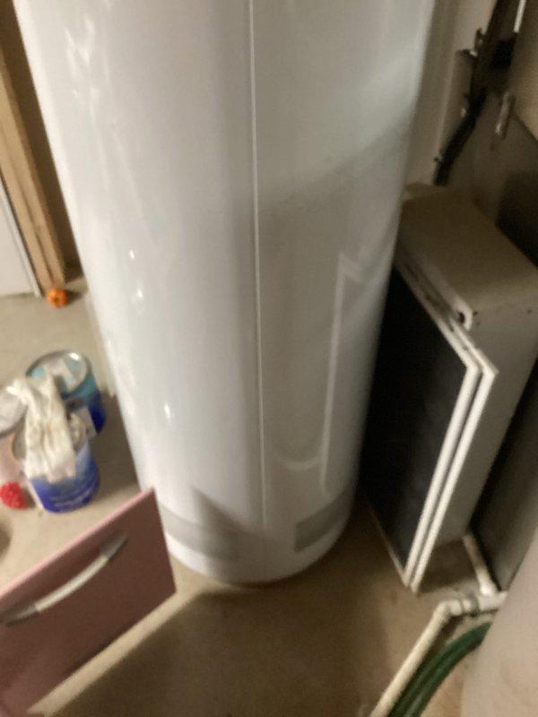 Conducted on-site assessment of existing 18-year-old residential water heater located in basement utility area. Evaluated current unit's capacity limitations and overall condition, noting standard atmospheric venting configuration with copper supply piping. Documented equipment specifications and installation environment through photographic documentation to provide accurate replacement recommendations and sizing requirements for new water heater installation.