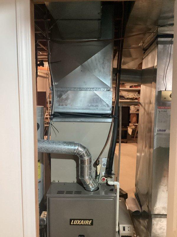 Conducted comprehensive assessment of non-operational 30-year-old HVAC system located in basement utility area. Evaluated existing Luxaire furnace and associated ductwork infrastructure, documenting extensive age-related deterioration including discolored and stained sheet metal ductwork with compromised structural integrity. Provided detailed equipment replacement estimate for complete system upgrade, including furnace unit, transition ductwork assemblies, and necessary modifications to existing galvanized metal distribution system to ensure proper airflow and code compliance.