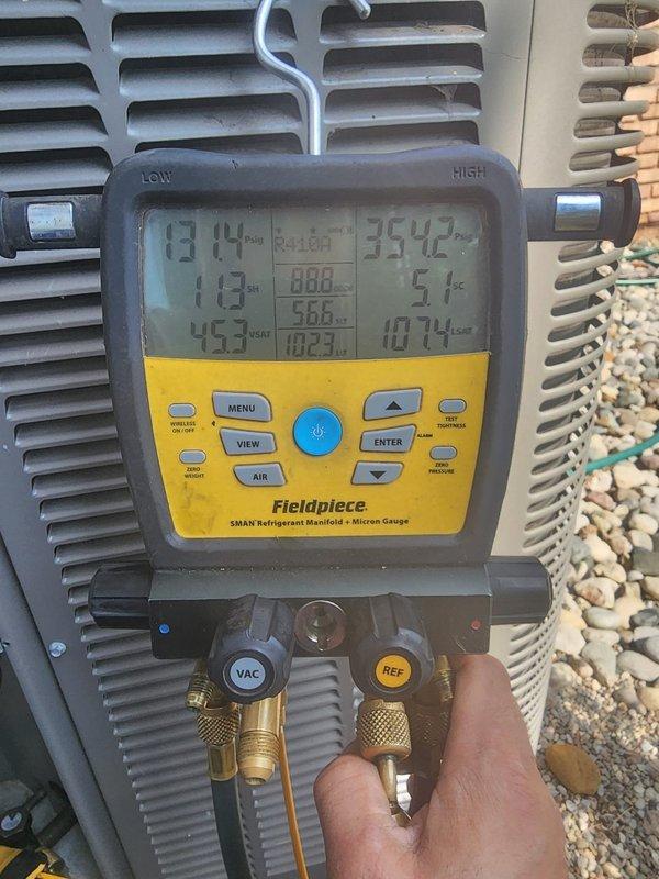 Performed routine maintenance on residential air conditioning system. Conducted system diagnostics using refrigerant manifold and micron gauge to verify operating pressures and temperatures across all zones. Inspected condenser unit exterior components, confirmed proper airflow through coil fins, and verified unit operation. All system parameters found within normal operating range.