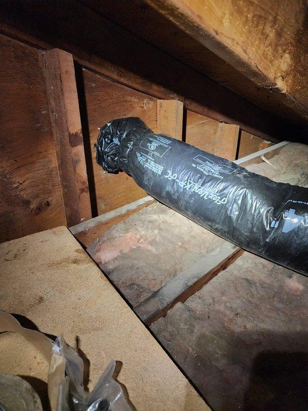 Completed electrical installation work in attic space requiring access through confined crawl area with existing HVAC ductwork and insulation. Navigated around black flexible duct system and fiberglass batt insulation to install or service electrical fixtures and outlets, ensuring all connections met code requirements in the limited-access environment.