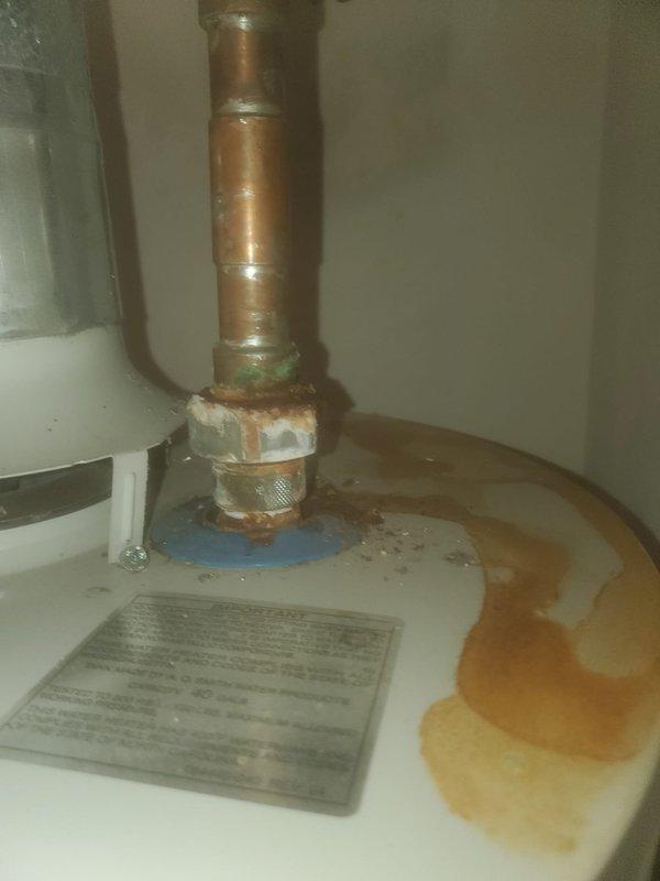 Completed scheduled AC maintenance visit. During inspection, discovered significant water leakage and corrosion at the water heater copper pipe connection, with visible rust staining on the enclosure floor and oxidation on pipe fittings. Documented condensate drain pump assembly condition, noting dust accumulation on the motor housing and mounting plate. Recommended repair of corroded water heater connections to prevent further damage and potential system failure.
