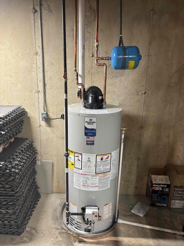 Completed installation of a 50-gallon residential tanked water heater in basement utility area. Established all necessary water supply connections using copper piping, integrated expansion tank for thermal protection, and completed electrical connections per code requirements. Unit was properly positioned, leveled, and tested for operational functionality with all safety systems verified and working correctly.