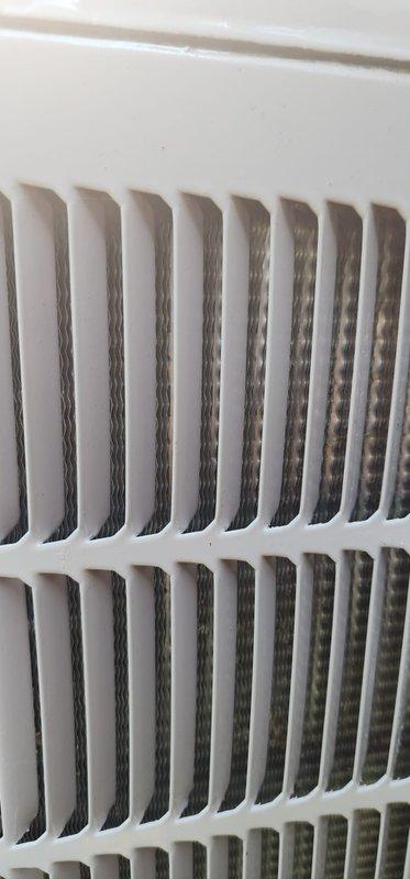 Completed routine seasonal AC tune-up on seven-year-old outdoor condensing unit. Performed comprehensive system inspection including evaporator coil assessment, which showed clean parallel fins in good condition. Inspected drain pan and found typical moisture residue and minor staining consistent with normal operation. Verified refrigerant lines showing natural copper oxidation, checked electrical connections and wire management, and confirmed all components functioning properly. Documented system condition through interior and exterior photographs. No issues identified; unit operating within normal parameters.