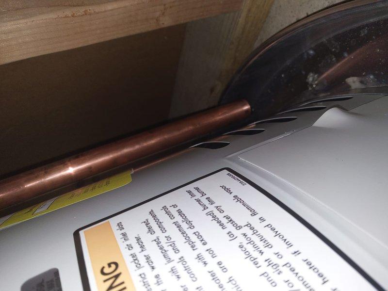 Completed warranty work to bring water heater relief valve discharge piping into compliance with Chapter 28 of the Michigan Residential Code. Replaced existing corroded copper discharge piping with new properly-sized piping, installed appropriate brass fittings, and routed discharge line to terminate in accordance with code requirements. All work photographed and documented per warranty protocol.