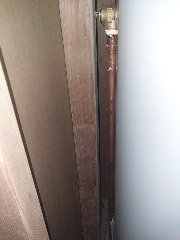 Completed warranty work to bring water heater relief valve discharge piping into compliance with Chapter 28 of the Michigan Residential Code. Replaced existing corroded copper discharge piping with new properly-sized piping, installed appropriate brass fittings, and routed discharge line to terminate in accordance with code requirements. All work photographed and documented per warranty protocol.