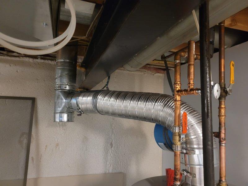 Installed a Bradford White 50-gallon natural gas tank water heater, Model RG250T6N, with 40,000 BTU/hr input capacity. Connected all necessary copper supply lines, gas piping, and exhaust venting to manufacturer specifications, ensuring proper clearances and compliance with ANSI Z21.10.1-2019/CSA 1.1-2019 standards for Category I natural draft appliances.