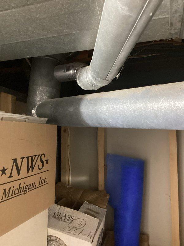 Conducted comprehensive assessment of existing HVAC system in basement installation, including furnace unit and associated ductwork. Unit confirmed to be over 10 years old with suspected clogging issues. Documented current equipment configuration, including copper refrigerant lines, PVC condensate drainage system, metallic ductwork, and furnace cabinet with filter access panel. Photographed complete installation layout for estimate preparation and replacement recommendation.